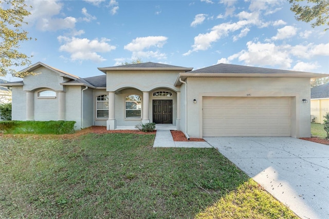 single story home featuring a garage and a front yard