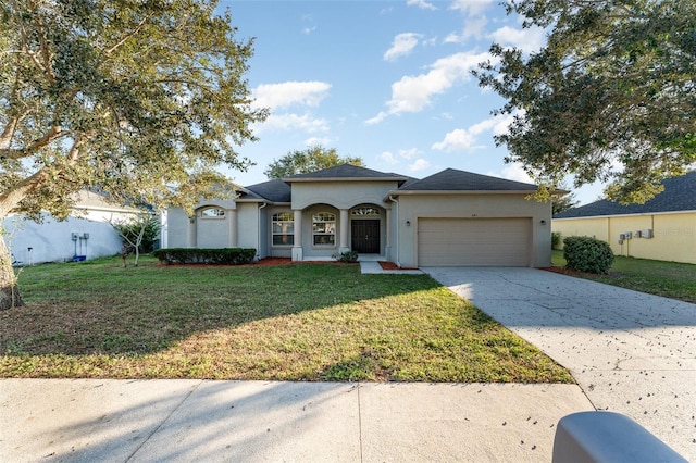 view of front of property featuring a front yard and a garage