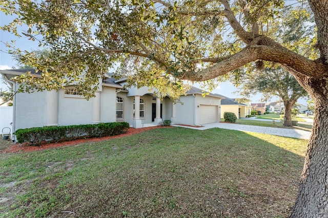 view of front of property with a garage and a front lawn