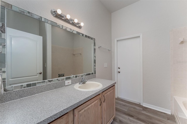 bathroom with hardwood / wood-style floors and vanity