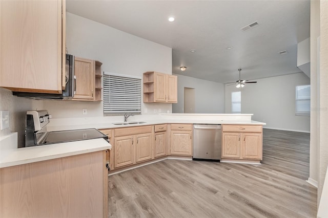 kitchen with range, sink, stainless steel dishwasher, light brown cabinetry, and kitchen peninsula