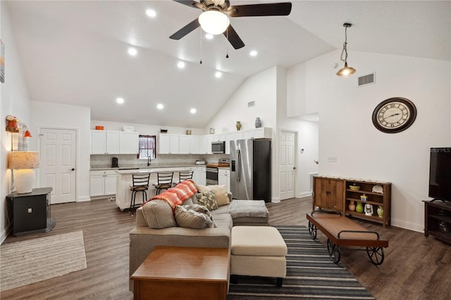 living room with high vaulted ceiling, ceiling fan, dark wood-type flooring, and sink