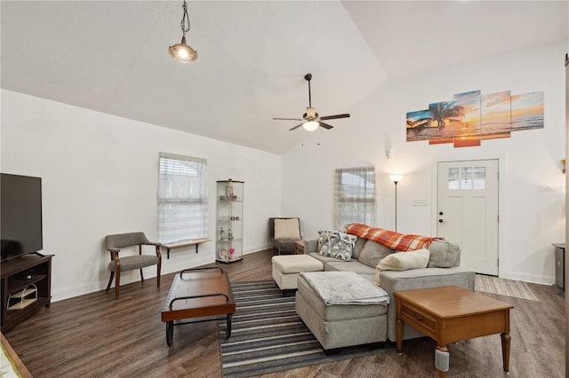 living room with ceiling fan, dark hardwood / wood-style flooring, and vaulted ceiling