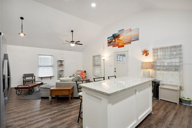 kitchen featuring stainless steel fridge, a kitchen breakfast bar, ceiling fan, white cabinets, and dark hardwood / wood-style floors