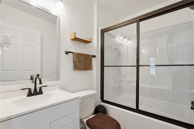 full bathroom featuring shower / bath combination with glass door, vanity, and toilet