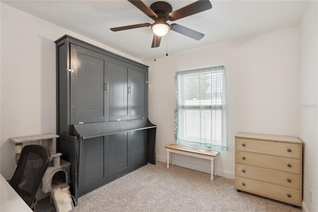 miscellaneous room featuring ceiling fan and light colored carpet