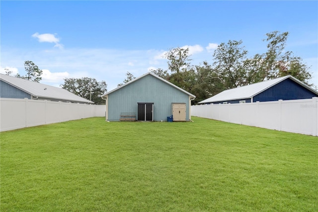 rear view of property with an outbuilding and a yard