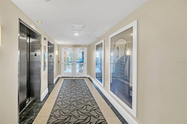 hallway with elevator and french doors