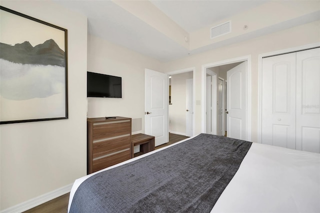 bedroom featuring dark hardwood / wood-style flooring and a closet