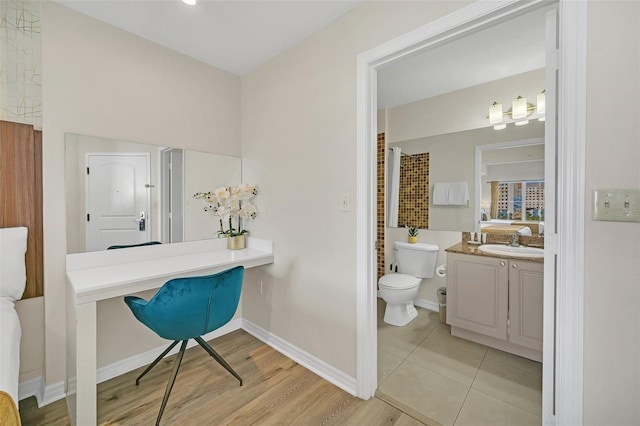 bathroom featuring vanity, hardwood / wood-style flooring, and toilet