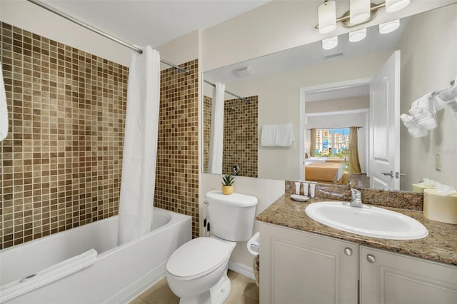 full bathroom featuring tile patterned floors, vanity, toilet, and shower / tub combo