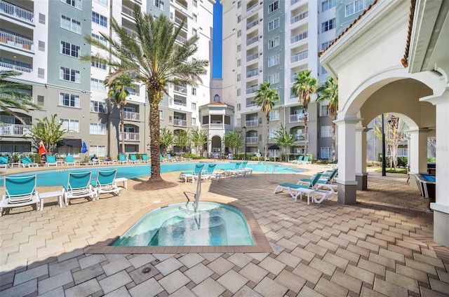 view of swimming pool with a community hot tub and a patio