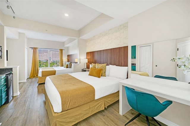 bedroom with light hardwood / wood-style floors and a closet