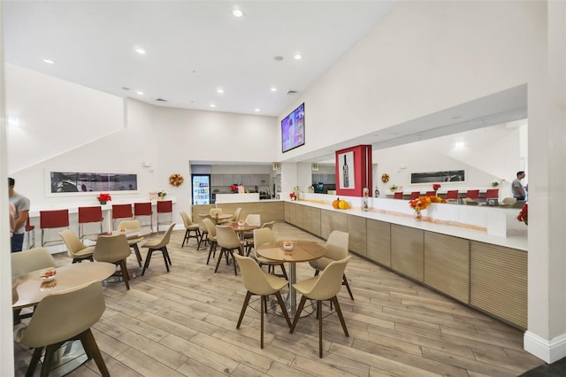 7383 Universal Blvd Unit 512, Orlando, FL 32819 - dining room featuring a towering ceiling, light wood finished floors, and recessed lighting