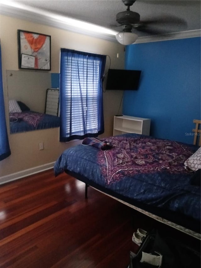 bedroom featuring wood finished floors, baseboards, and ceiling fan