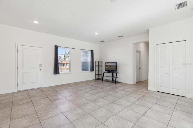 unfurnished living room with light tile patterned flooring