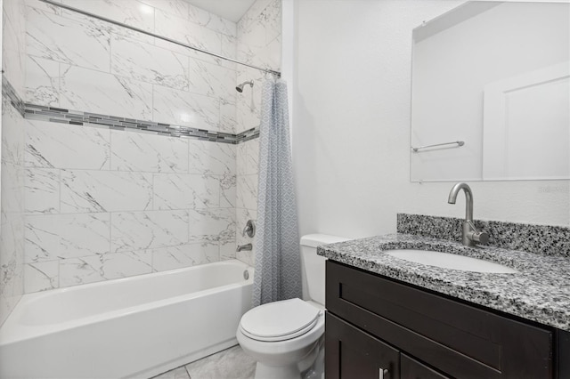 full bathroom with vanity, tiled shower / bath combo, and toilet