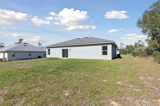 rear view of house featuring a yard