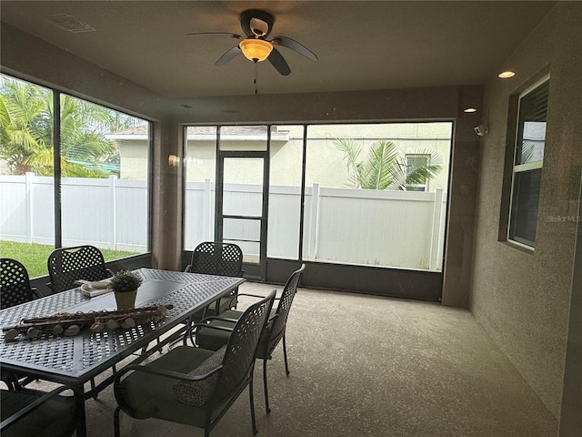 sunroom with ceiling fan