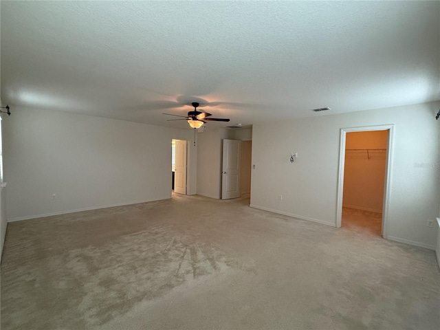 spare room with light colored carpet and ceiling fan