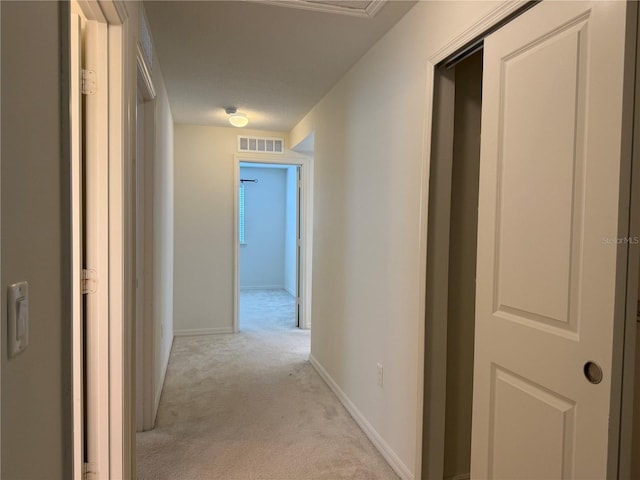 hallway featuring light carpet