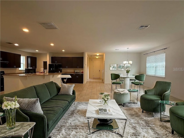 living room featuring a chandelier and light tile patterned floors