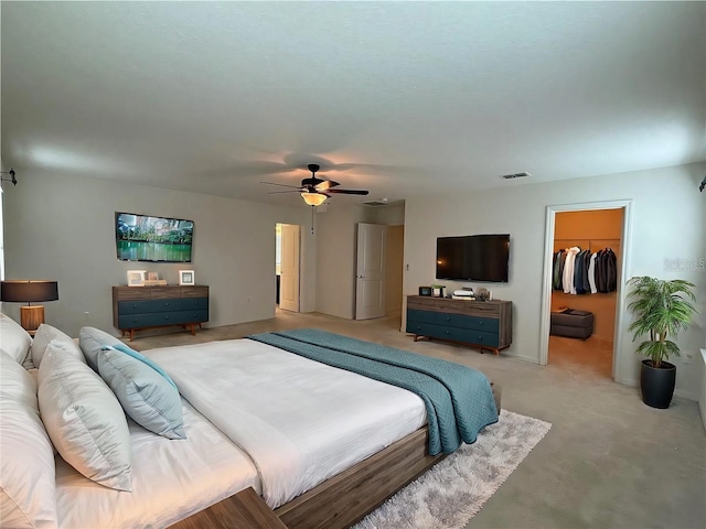 bedroom with a closet, a spacious closet, and ceiling fan