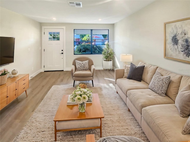 living room with light hardwood / wood-style flooring