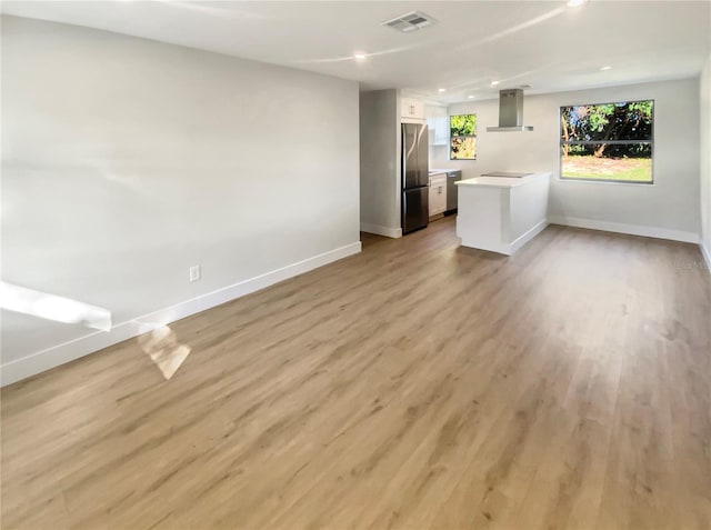 unfurnished living room with light hardwood / wood-style floors