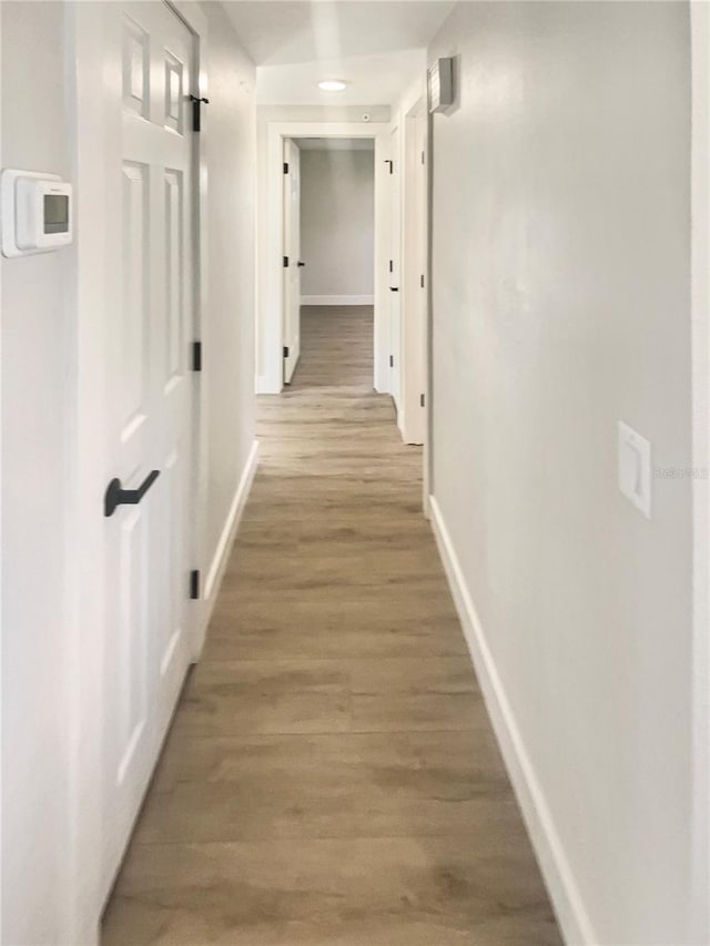 corridor featuring hardwood / wood-style floors