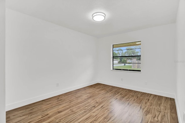 empty room with light hardwood / wood-style flooring