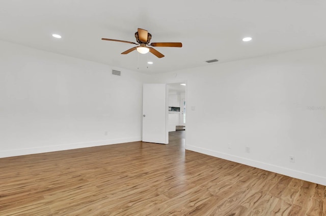 spare room with ceiling fan and light hardwood / wood-style flooring