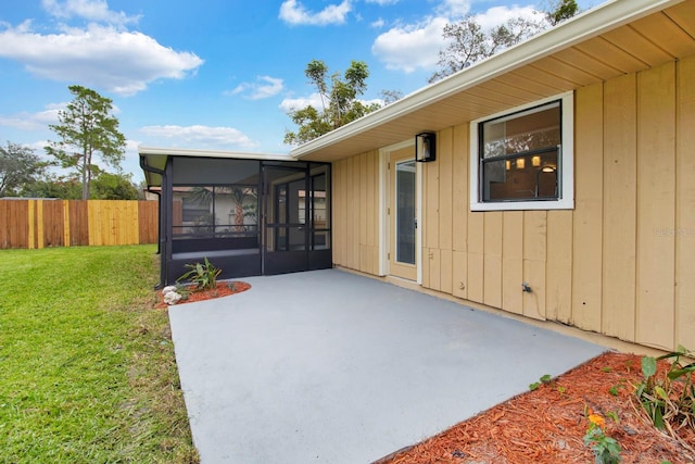 doorway to property featuring a lawn and a patio