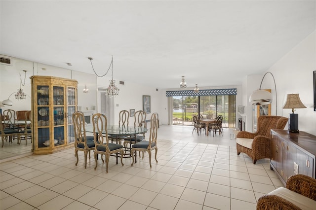 dining room featuring light tile patterned floors and a notable chandelier