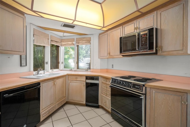 kitchen featuring light brown cabinets, sink, light tile patterned floors, and black appliances