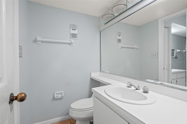 bathroom featuring toilet, vanity, and tile patterned floors