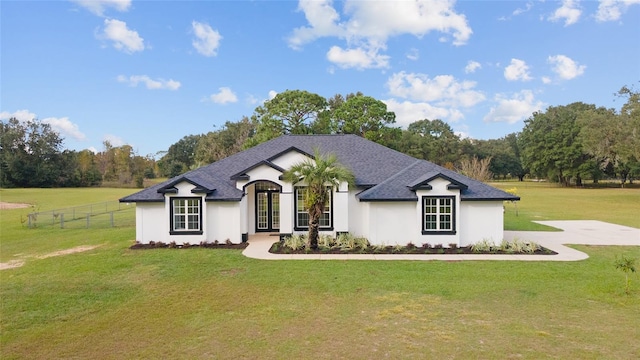 french country home featuring a front lawn