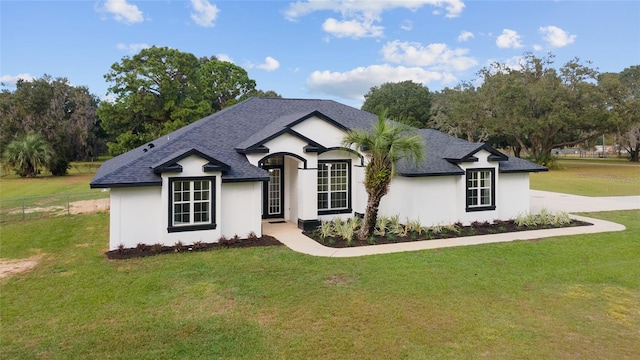 french country style house featuring a front lawn