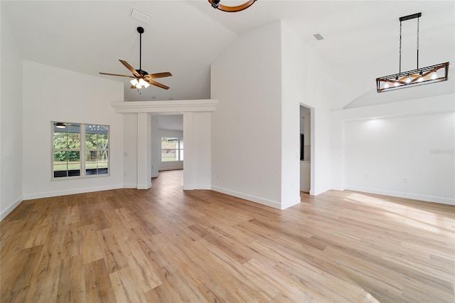 unfurnished living room featuring ceiling fan, light hardwood / wood-style floors, and high vaulted ceiling