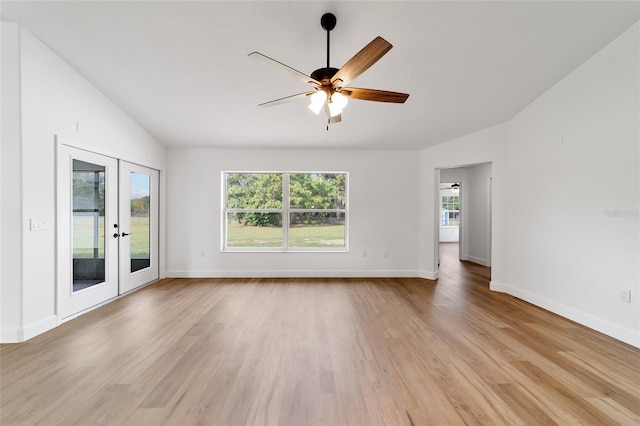 empty room with french doors, light hardwood / wood-style flooring, plenty of natural light, and ceiling fan