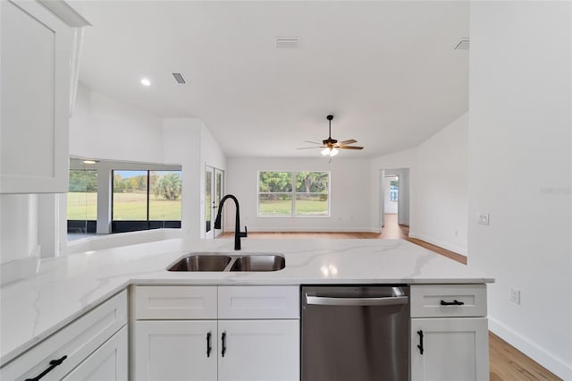 kitchen featuring dishwasher, white cabinetry, light stone countertops, and sink