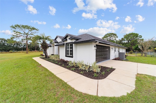 view of front of property featuring central AC, a front lawn, and a garage