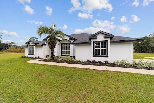 ranch-style home with a front lawn