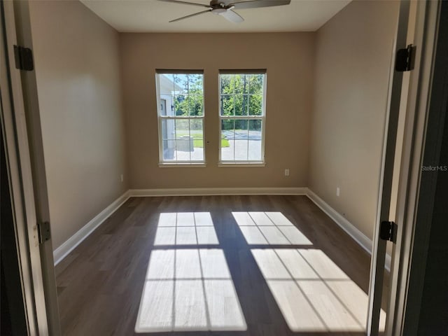 empty room featuring ceiling fan and dark wood-type flooring