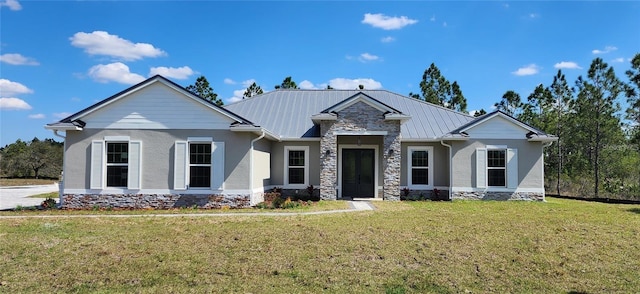 craftsman house featuring a front yard, stucco siding, metal roof, stone siding, and a standing seam roof