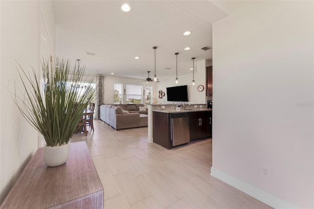 kitchen with dark brown cabinetry, light stone countertops, ceiling fan, dishwasher, and hanging light fixtures