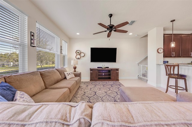 carpeted living room with ceiling fan