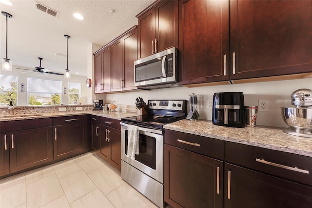 kitchen featuring light stone countertops, appliances with stainless steel finishes, a textured ceiling, ceiling fan, and hanging light fixtures