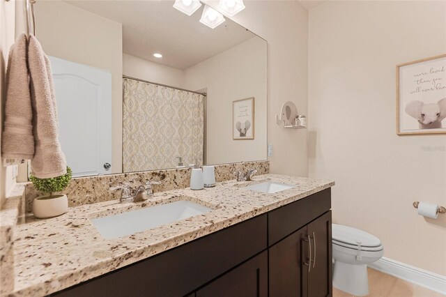 bathroom with tile patterned floors, vanity, and toilet