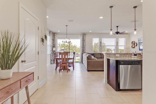 kitchen with dishwasher, light stone counters, ceiling fan with notable chandelier, and decorative light fixtures